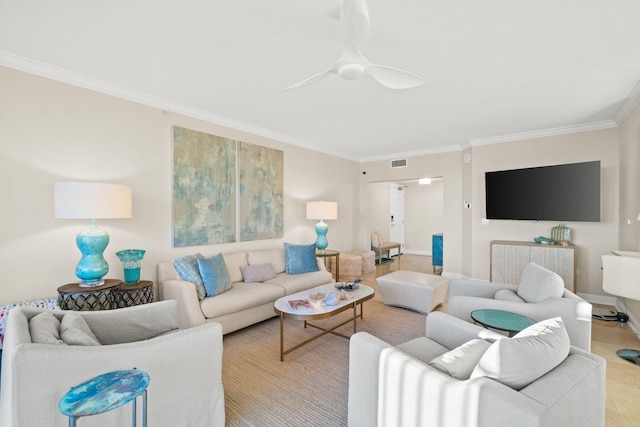 living area with visible vents, baseboards, crown molding, and a ceiling fan