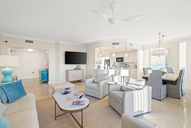 living area featuring visible vents, baseboards, ceiling fan, and crown molding