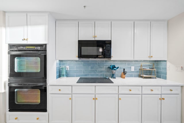 kitchen featuring decorative backsplash, white cabinetry, black appliances, and light countertops