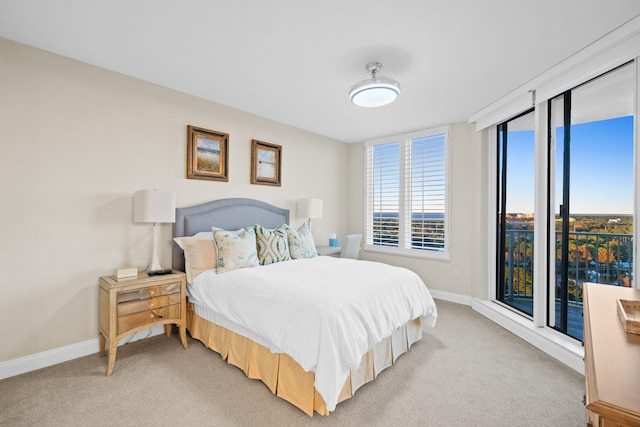 bedroom featuring light carpet and baseboards