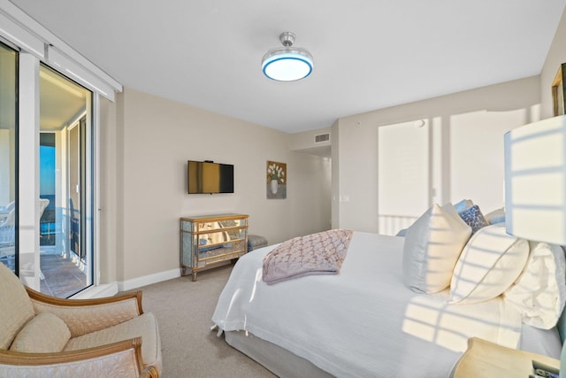 carpeted bedroom with visible vents, multiple windows, and baseboards