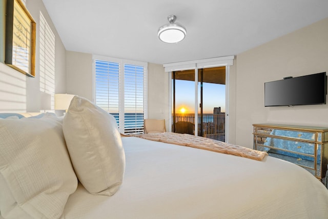 bedroom featuring access to exterior and floor to ceiling windows