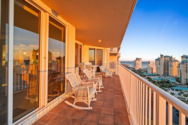 balcony featuring a view of city and a water view