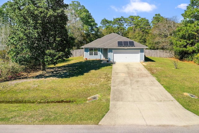 view of front facade with a front lawn, solar panels, driveway, and fence