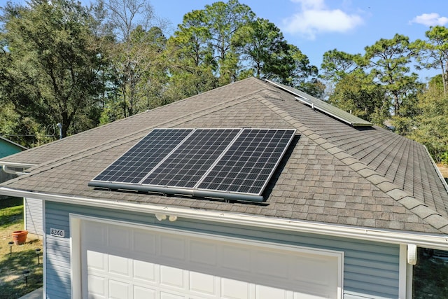 garage featuring roof mounted solar panels