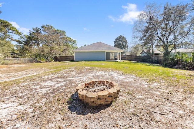 view of yard featuring an outdoor fire pit and a fenced backyard