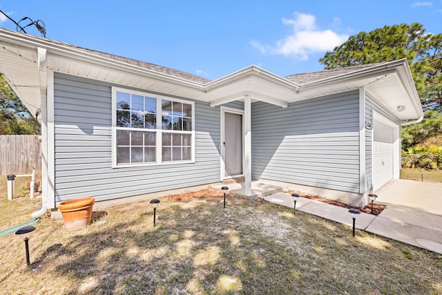 ranch-style house with fence, a garage, and driveway