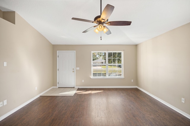 spare room featuring ceiling fan, baseboards, and wood finished floors