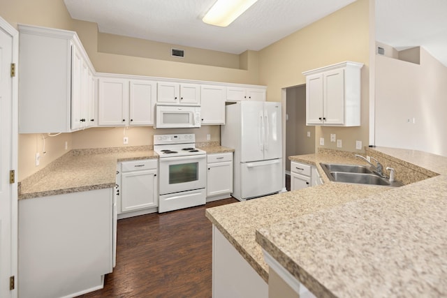 kitchen featuring white appliances, visible vents, a sink, light countertops, and white cabinets