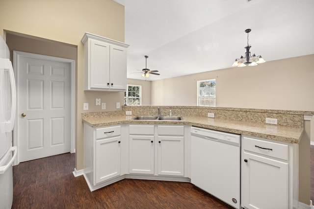 kitchen with a sink, dark wood finished floors, white appliances, a peninsula, and light countertops