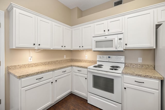 kitchen featuring white cabinetry, white appliances, light countertops, and visible vents