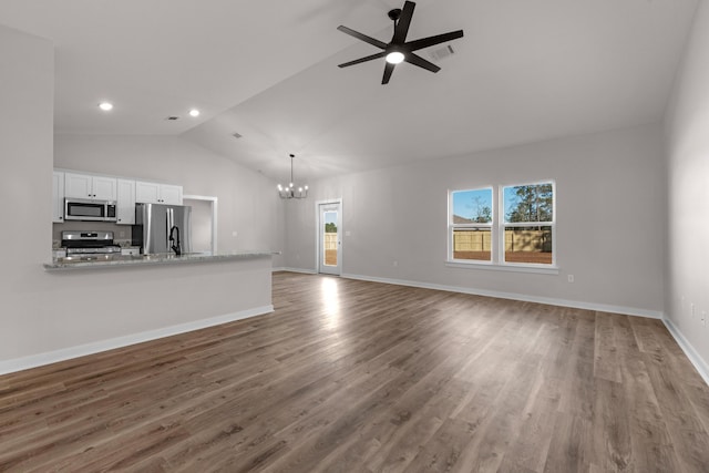 unfurnished living room featuring visible vents, baseboards, recessed lighting, ceiling fan with notable chandelier, and wood finished floors