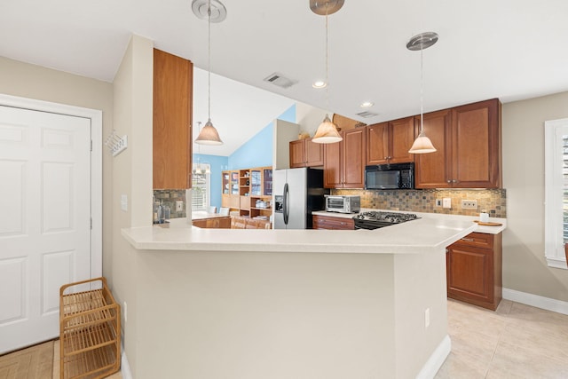 kitchen featuring tasteful backsplash, visible vents, light countertops, appliances with stainless steel finishes, and brown cabinetry