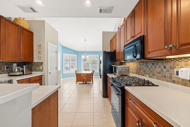 kitchen with black appliances, light tile patterned floors, visible vents, and lofted ceiling