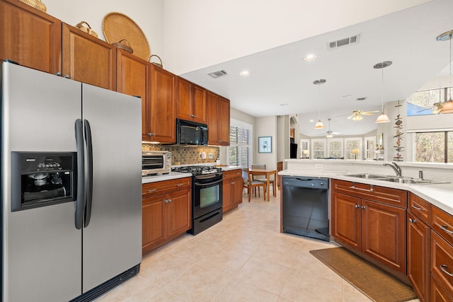 kitchen with ceiling fan, black appliances, visible vents, and a sink