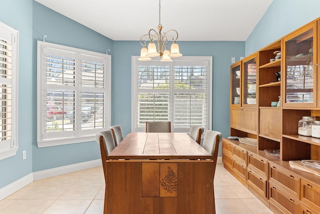 dining room featuring a chandelier, light tile patterned floors, and baseboards