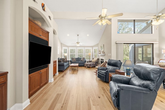 living area featuring light wood-style flooring, a healthy amount of sunlight, and ceiling fan