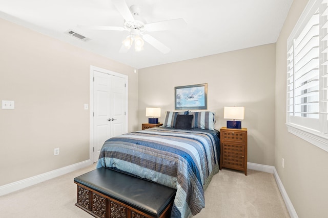 bedroom with a closet, visible vents, baseboards, and carpet floors