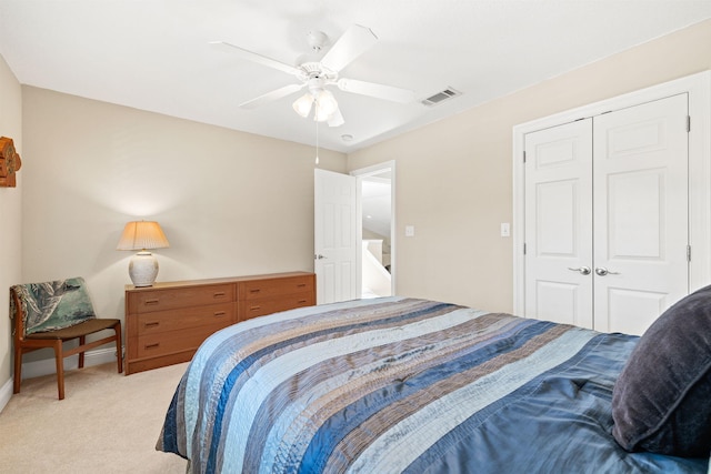 bedroom with a ceiling fan, baseboards, visible vents, a closet, and light carpet