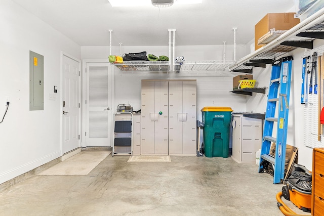 garage featuring electric panel and baseboards