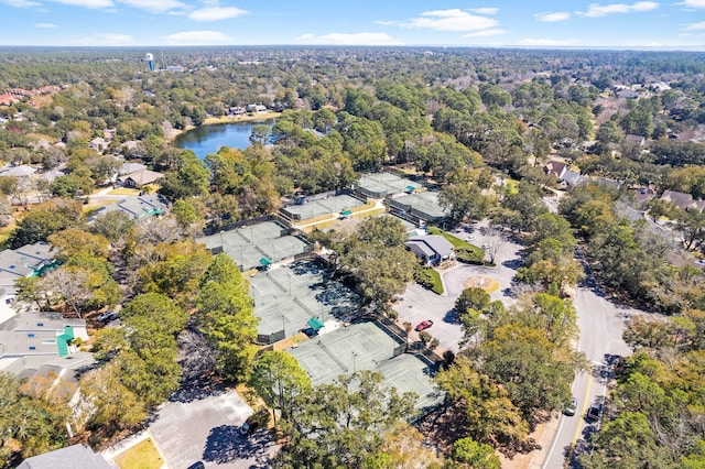 bird's eye view featuring a forest view and a water view