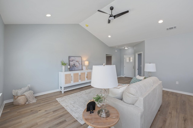 living area with wood finished floors, baseboards, visible vents, lofted ceiling, and ceiling fan