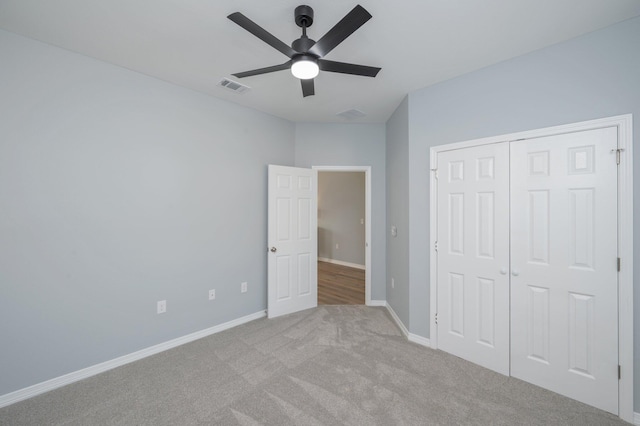 unfurnished bedroom with visible vents, a closet, carpet, baseboards, and ceiling fan