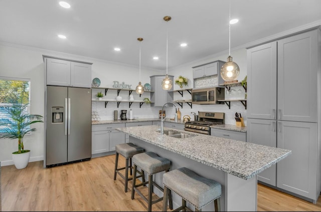 kitchen with open shelves, a sink, ornamental molding, gray cabinetry, and appliances with stainless steel finishes