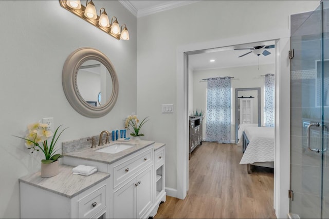 bathroom with vanity, wood finished floors, ensuite bath, ceiling fan, and ornamental molding