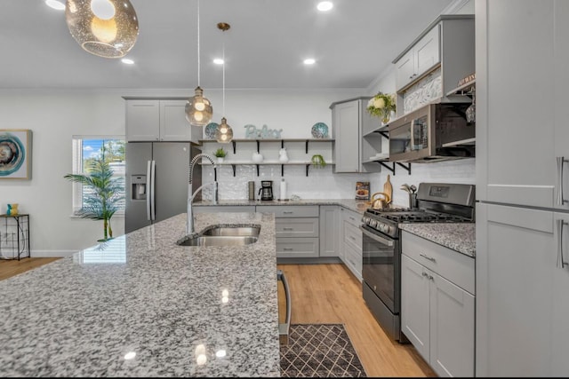 kitchen with open shelves, a sink, gray cabinetry, stainless steel appliances, and crown molding