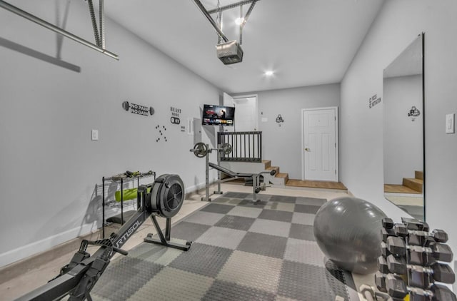 workout room with baseboards and a garage