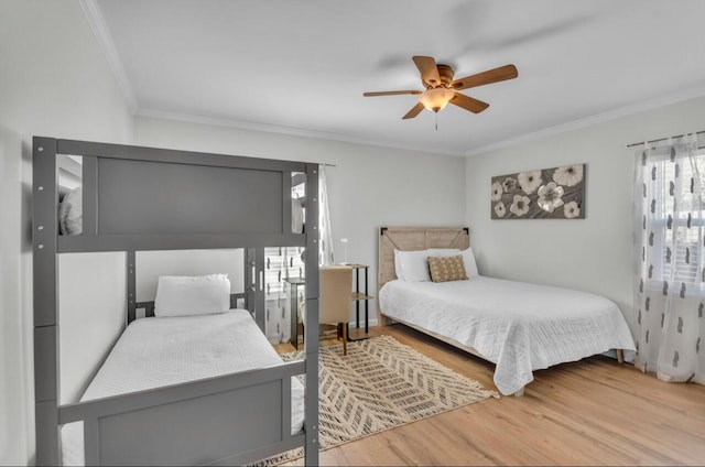 bedroom featuring wood finished floors, a ceiling fan, and ornamental molding