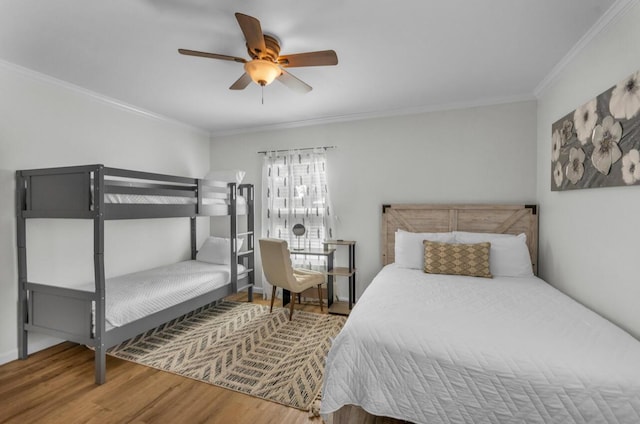 bedroom featuring a ceiling fan, wood finished floors, and ornamental molding