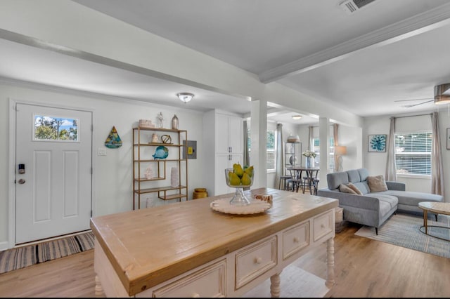 dining room with visible vents, crown molding, and light wood-type flooring