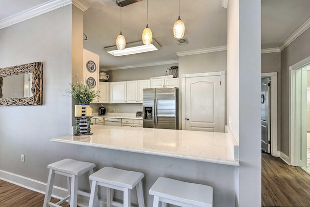 kitchen with visible vents, crown molding, stainless steel fridge with ice dispenser, dark wood finished floors, and a peninsula