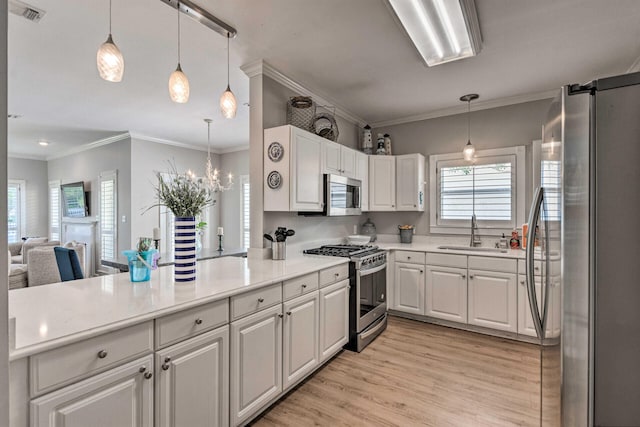 kitchen featuring visible vents, plenty of natural light, stainless steel appliances, and a sink