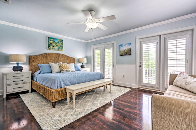 bedroom featuring visible vents, crown molding, a wainscoted wall, wood finished floors, and access to outside