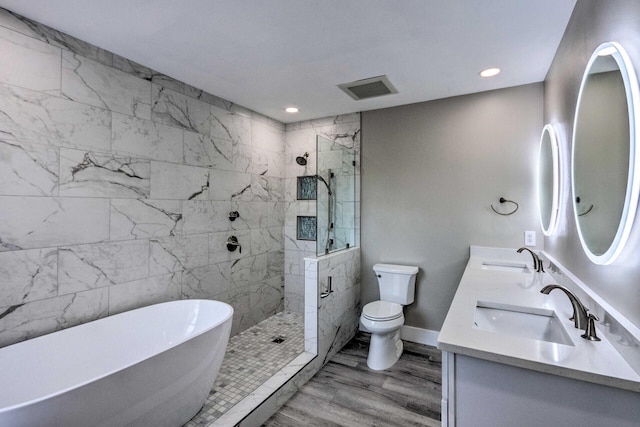 full bath featuring a sink, visible vents, toilet, and a soaking tub