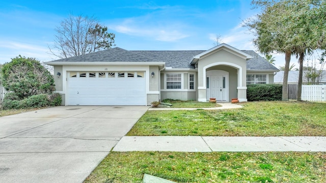 ranch-style house featuring stucco siding, a front lawn, fence, concrete driveway, and an attached garage