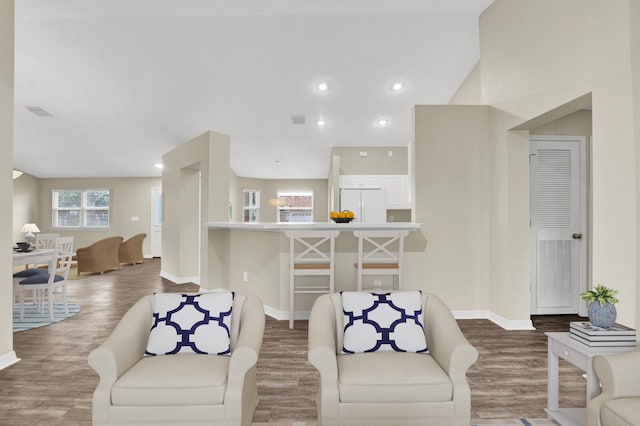 living room featuring recessed lighting, baseboards, and wood finished floors