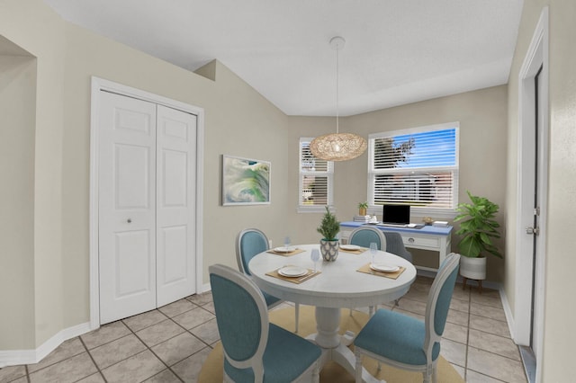 dining space featuring light tile patterned floors and baseboards