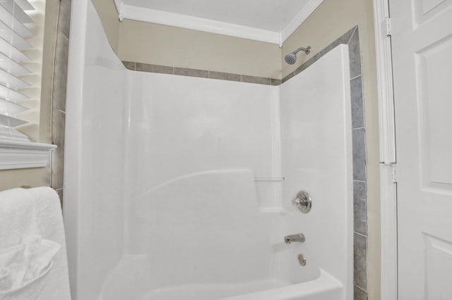 bathroom featuring ornamental molding and  shower combination