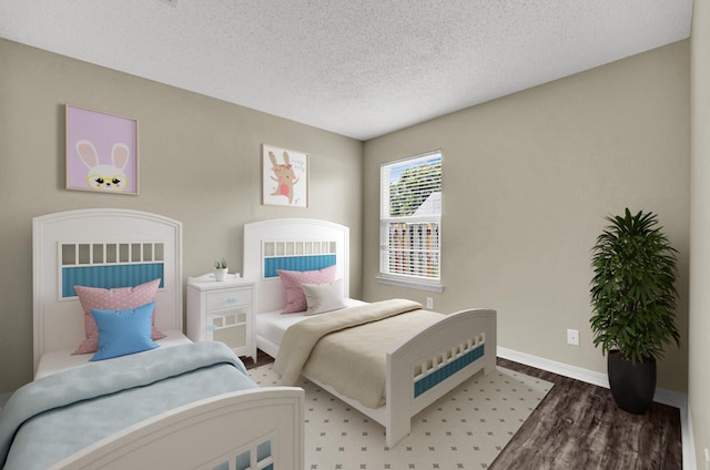 bedroom featuring a textured ceiling, baseboards, and wood finished floors