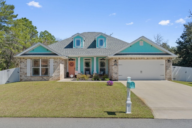 view of front of house with a gate, concrete driveway, a front yard, and fence