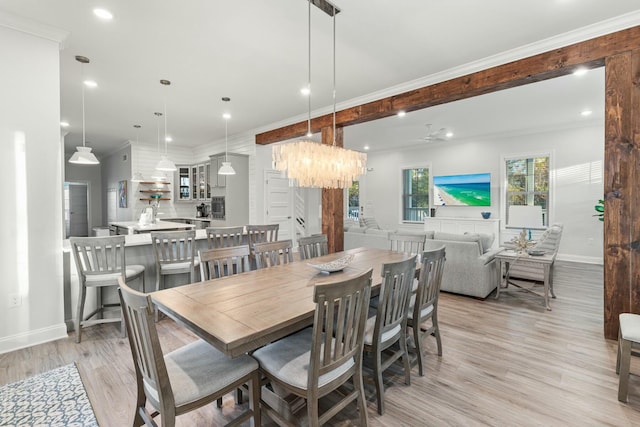 dining area with light wood finished floors, recessed lighting, crown molding, and baseboards