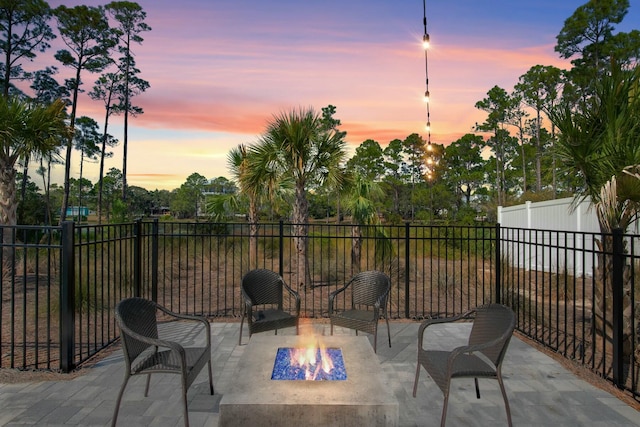 view of patio / terrace featuring a fire pit and fence