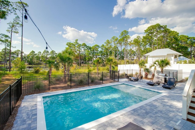 view of swimming pool featuring a fenced in pool, a fenced backyard, and a patio area