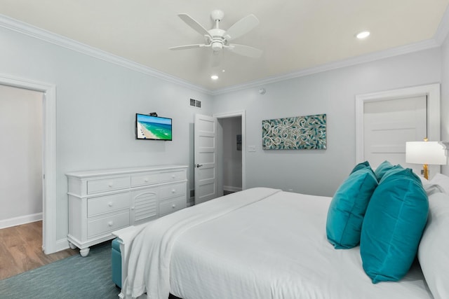 bedroom with wood finished floors, recessed lighting, crown molding, baseboards, and ceiling fan