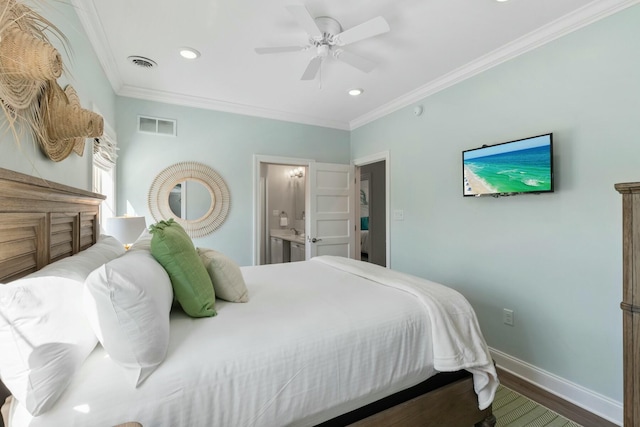 bedroom with visible vents, wood finished floors, baseboards, and ornamental molding