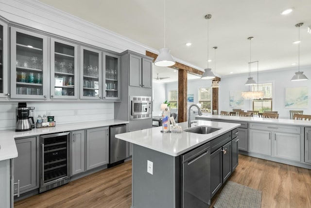 kitchen featuring wine cooler, gray cabinetry, and stainless steel appliances